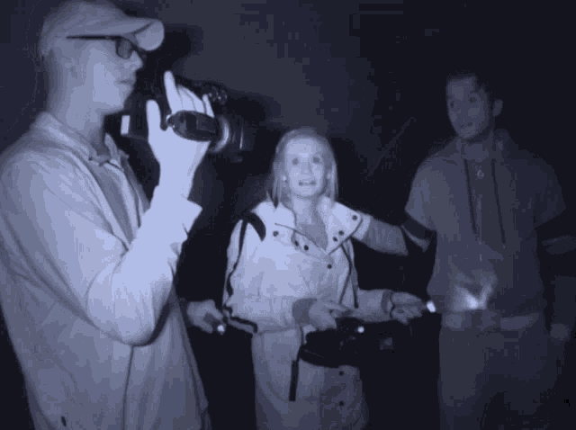 a man is taking a picture of a woman in a white jacket