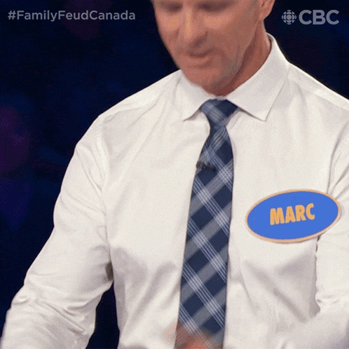 a man in a white shirt and blue tie has a name tag that says marc