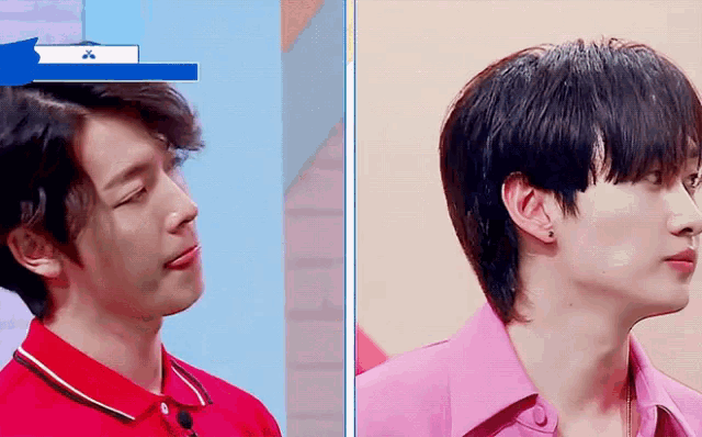 a man in a red shirt and a man in a pink shirt are looking at each other .