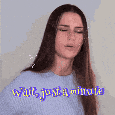 a woman in a blue sweater says wait just a minute in purple letters