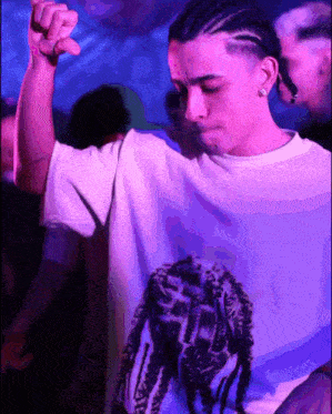 a man wearing a white shirt with a picture of a shoe on the back
