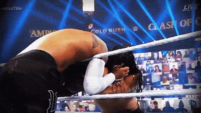 two wrestlers in a wrestling ring with clash of champions written on the screen