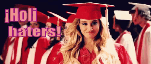 a woman in a graduation cap and gown stands in front of a group of graduates with the words holi haters behind her