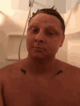 a shirtless man with a tattoo on his chest