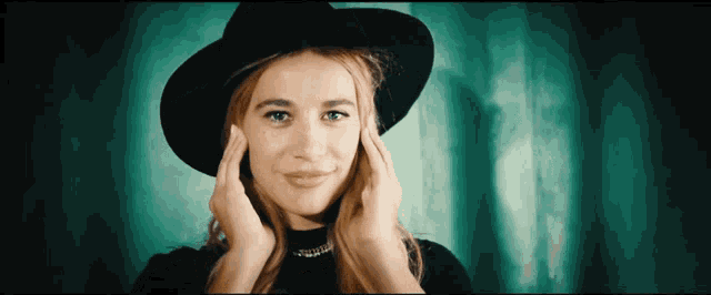 a woman wearing a black hat covering her ears