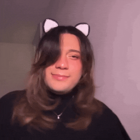 a young woman wearing a cat ear headband and a black turtleneck .