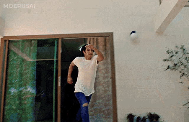 a man in a white shirt is running through a sliding glass door with the word moerusai written on the bottom