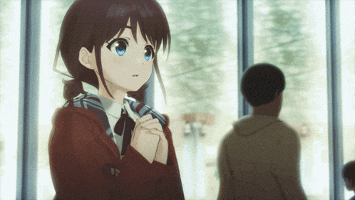 a girl with blue eyes is standing in front of a window with a man standing behind her