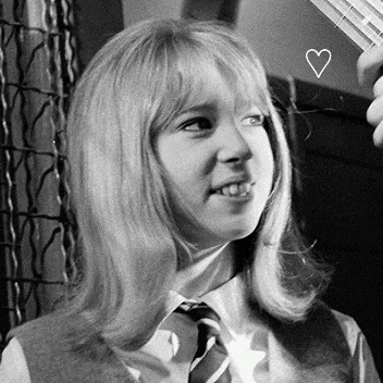 a black and white photo of a young girl with a heart drawn in her hair