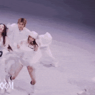 a group of people are dancing in front of a sign that says com on it