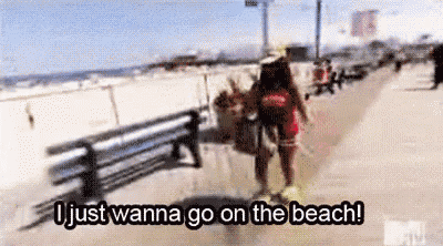 a woman is walking down a beach with a bench in the background and the words `` i just wanna go on the beach '' .