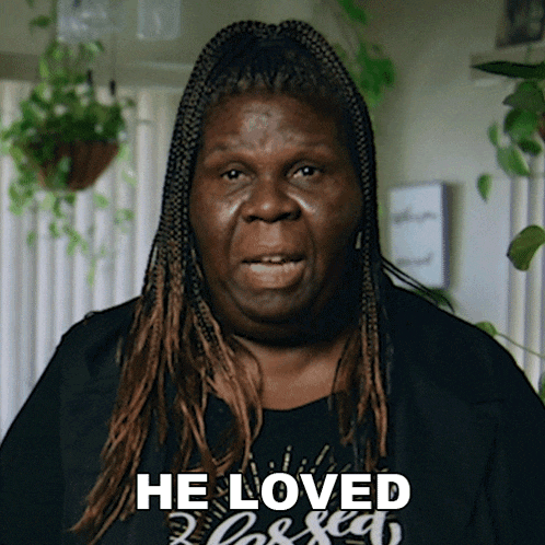 a woman with braids is wearing a black shirt that says he loved