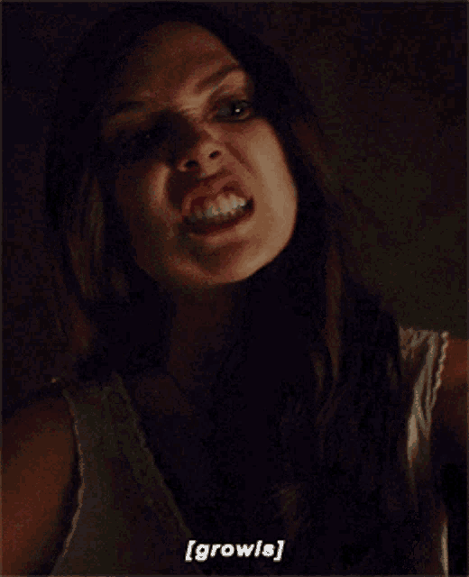 a close up of a woman making a funny face and the words [ growls ] below her
