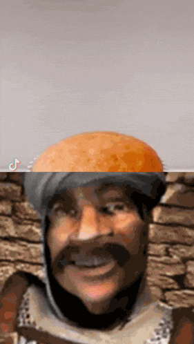 a close up of a man 's face with a bread on his head