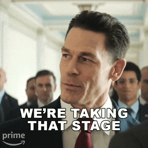 a man in a suit and tie with the words we 're taking that stage