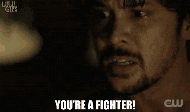 a close up of a man 's face with the words you 're a fighter below him