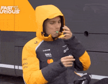 a man wearing a dell jacket is eating something