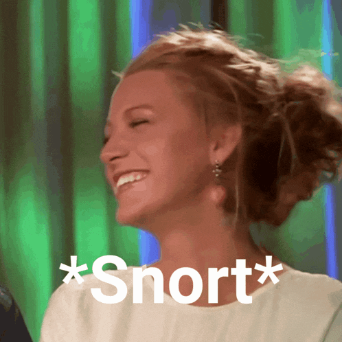 a woman is laughing with the words * snort * written on her shirt