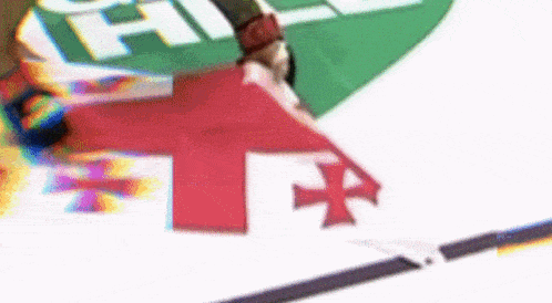 a person is holding a red and white flag with a cross on it