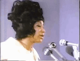 a woman singing into a microphone with the abc logo on the bottom