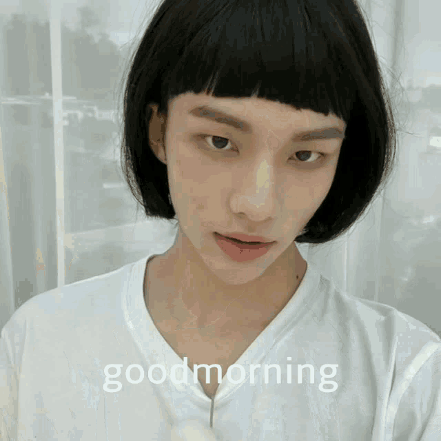 a person wearing a white shirt with the words " good morning " on the bottom