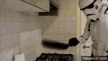 a storm trooper is throwing a frying pan in the air .