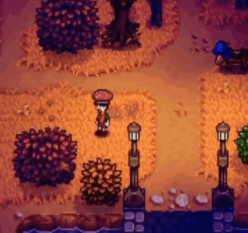 a video game scene with a person standing on a path surrounded by trees and shrubs .