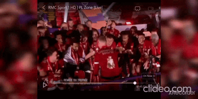 a group of soccer players are celebrating with a trophy