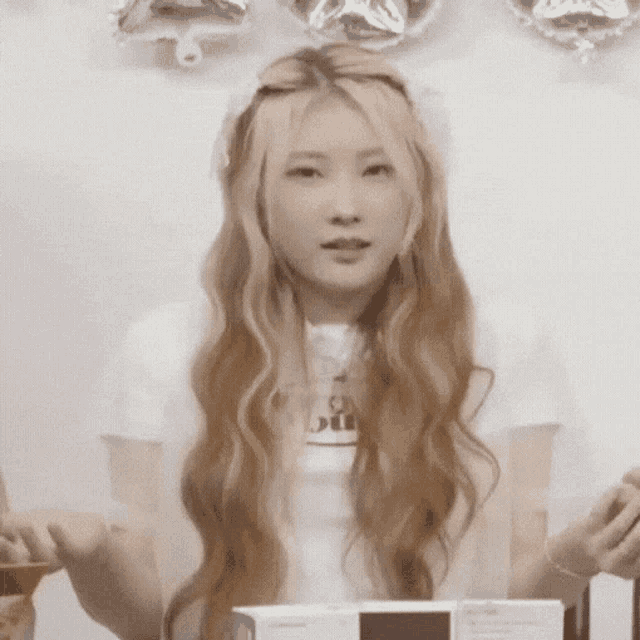 a woman with long blonde hair is wearing a white t-shirt that says ' i 'm sorry ' on it