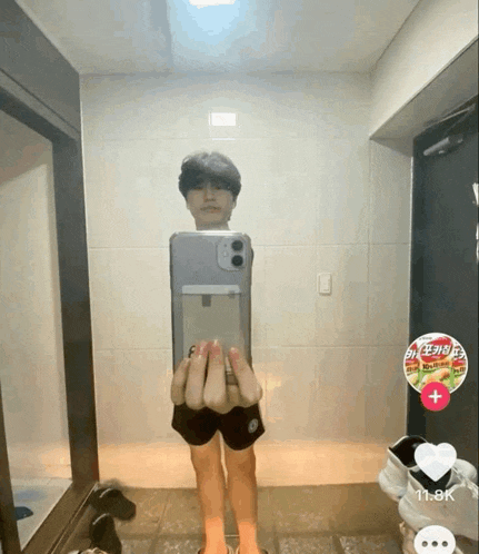 a person is taking a picture of themselves in a mirror with a sticker on the wall that says ' ramen '