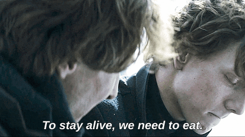 two men looking at each other with the words to stay alive we need to eat above them