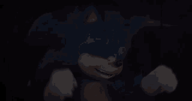 a close up of a blue sonic the hedgehog in the dark