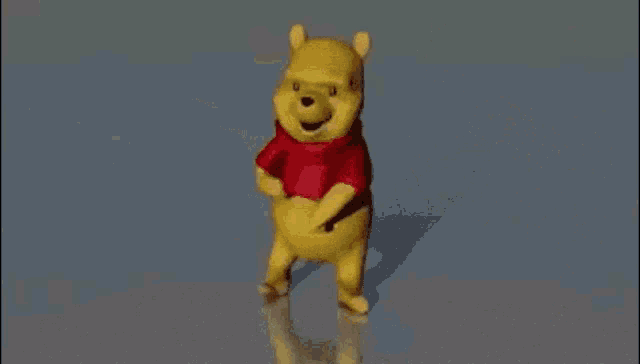 a winnie the pooh bear is dancing in front of chinese characters
