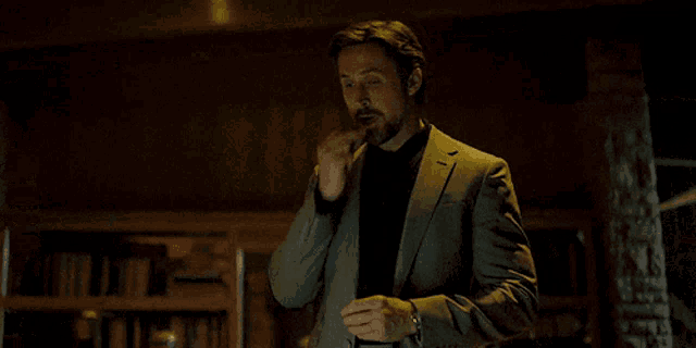 a man in a suit has a watch on his wrist that says rolex on it