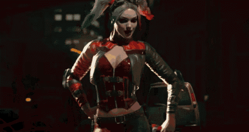 harley quinn is standing in front of a fire with her hands on her hips .