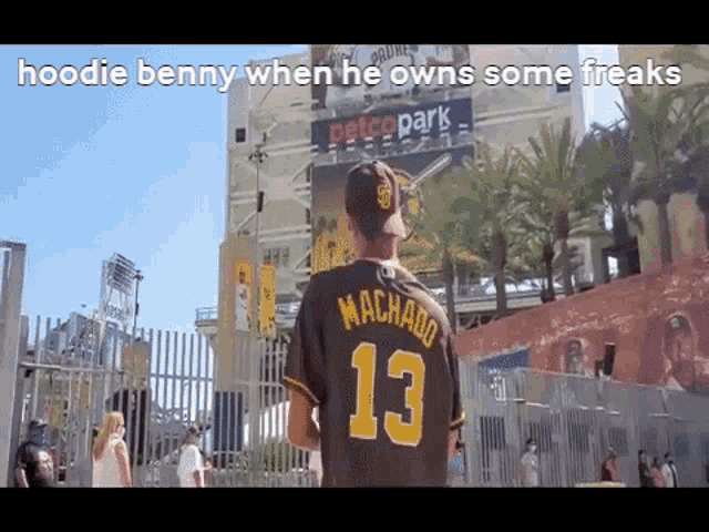 a man wearing a baseball jersey with the number 13