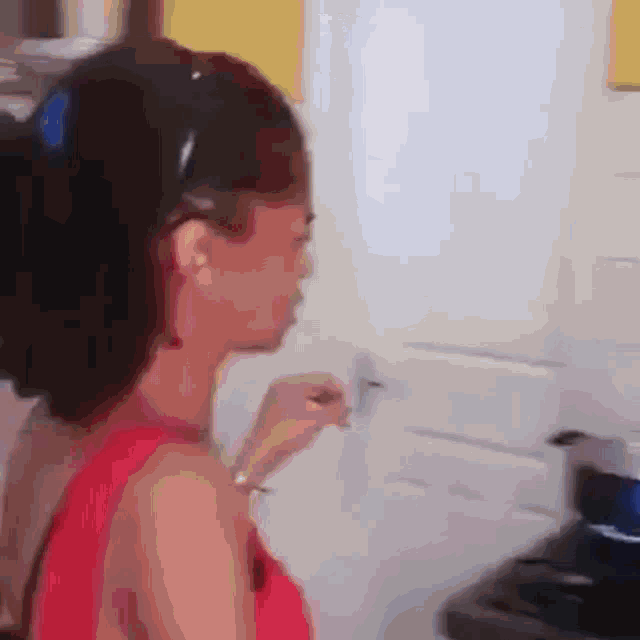 a woman in a red dress is opening a door with a key