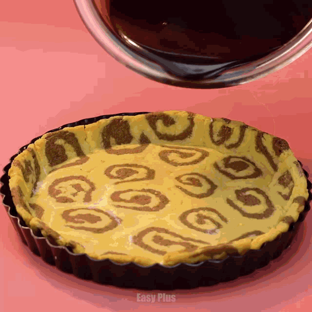 a pie with a leopard print is being poured into a pan with easy plus written on the bottom