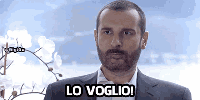 a man in a suit says lo voglio in front of white flowers