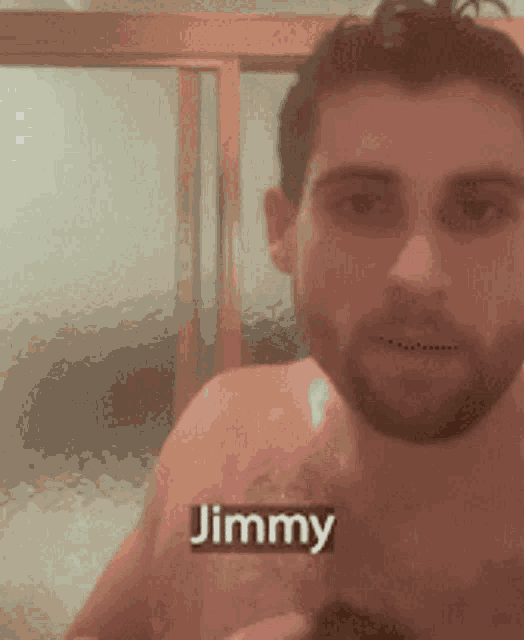 a shirtless man is taking a bath and the name jimmy is visible on his chest