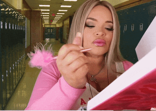 a woman in a pink shirt with the letter a on the front
