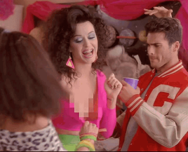a man in a red jacket with the letter c on it is standing next to a woman in a pink top