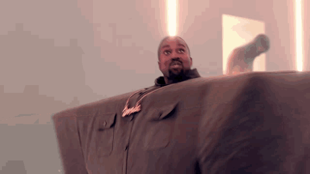 a man with a beard is wearing a jacket that looks like a giant couch .