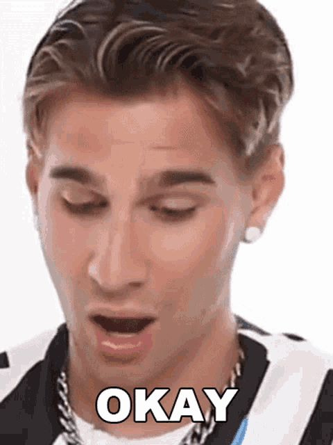 a close up of a man 's face with his mouth open and the word okay on it .