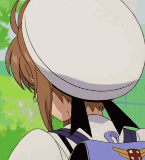 a girl wearing a white hat and a backpack with a cross on it