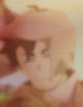 a blurred image of a person wearing a helmet with the letter s on it