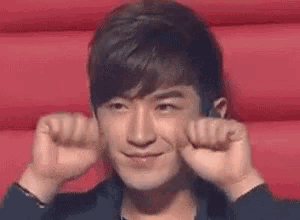 a close up of a man making a funny face with his hands .