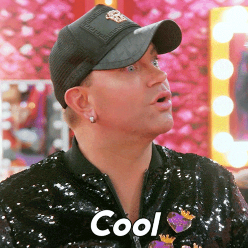 a man wearing a black hat and a sequined jacket is saying cool