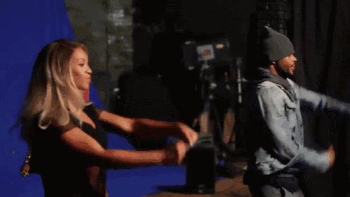 a man and a woman are dancing on a stage