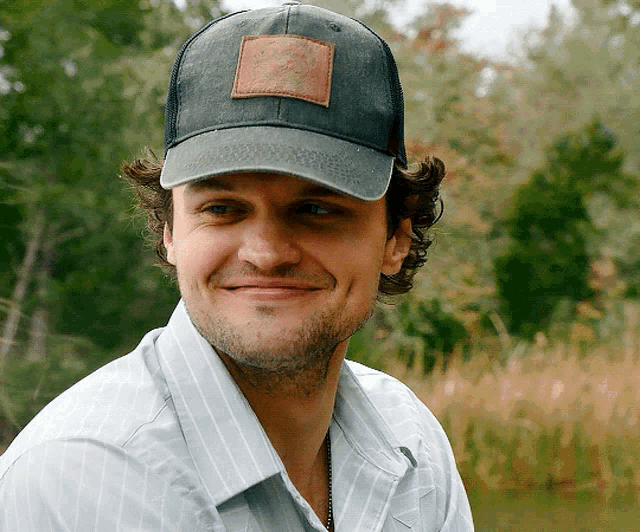 a man wearing a hat with a patch on it that says ' columbia ' on it
